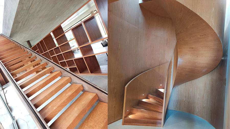 Ambiente interno com um armário de madeira com diversas divisórias e na frente uma escada de madeira reta. Ao lado, uma escada caracol com soleira em Cumaru Demolição.